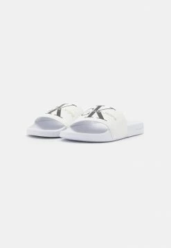 Calvin Klein Jeans SLIDE MONOGRAM - Mules - Bright White -Calvin Klein Elegant Magasin 25739095714d4cd5adca4f5f4223328b