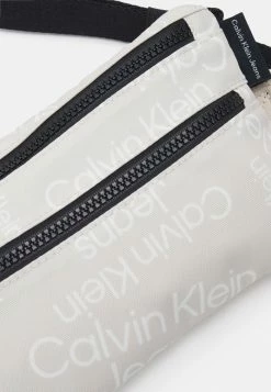 Calvin Klein Jeans STACK LOGO WAISTBAG UNISEX - Sac Banane - Eggshell Stacked Logo Aop -Calvin Klein Elegant Magasin 3c449bf4ba9542ae8db12b950050a18a