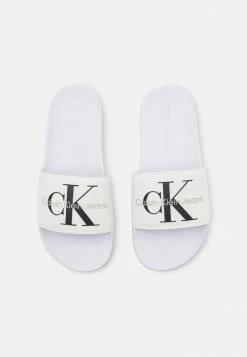 Calvin Klein Jeans SLIDE MONOGRAM - Mules - Bright White -Calvin Klein Elegant Magasin 489740646b13415a8f6d71f69b3816d3