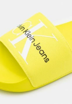 Calvin Klein Jeans SLIDE MONOGRAM - Mules - Lemon Lime -Calvin Klein Elegant Magasin 63514c0669bc40fbba5062a4938f661b