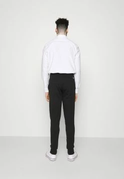 Calvin Klein Jeans VERTICAL INSTITUTIONAL PANT - Pantalon De Survêtement - Black -Calvin Klein Elegant Magasin 642fd47b5c55465396efcfc5ebf91d44