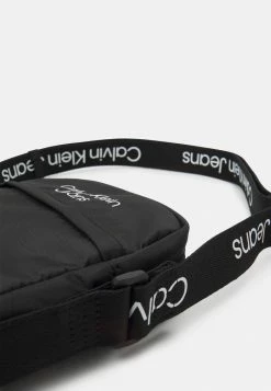 Calvin Klein Jeans LOGO TAPE CROSSBODY UNISEX - Sac Bandoulière - Black -Calvin Klein Elegant Magasin 6557874df9a445d78f44bf697ddf39ec