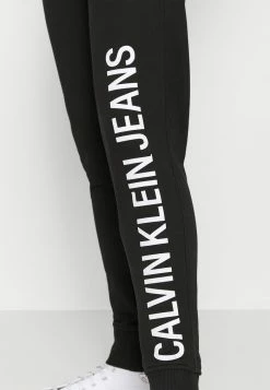 Calvin Klein Jeans VERTICAL INSTITUTIONAL PANT - Pantalon De Survêtement - Black -Calvin Klein Elegant Magasin 665888edb36c4c91a80e7f50810480ca