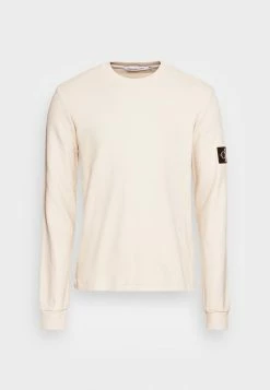Calvin Klein Jeans MONOGRAM BADGE WAFFLE TEE - Sweatshirt - Eggshell -Calvin Klein Elegant Magasin b3d57a8314144e7cb400c2fae36a9e31