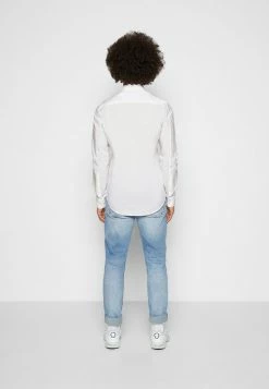 Calvin Klein Jeans CHEST LOGO SLIM STRETCH SHIRT - Chemise - Bright White -Calvin Klein Elegant Magasin d16fcfbb621741959109bcdd643f2502